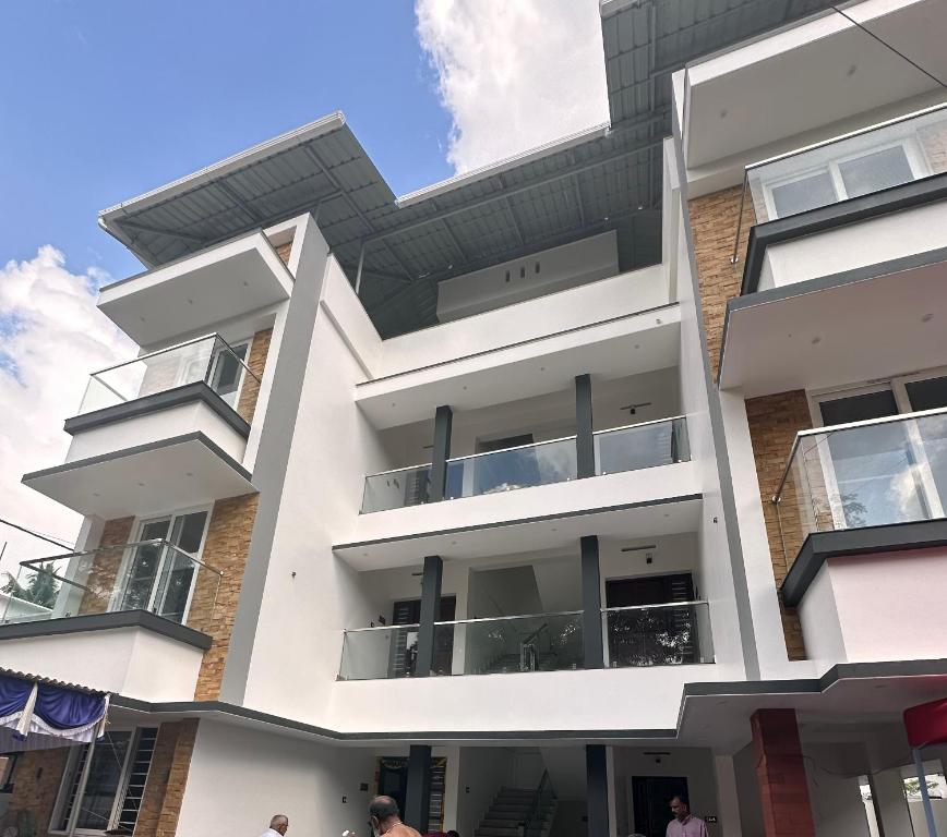 a building with balconies on the side of it at G3 Gayathri Enclave Fully furnished 2BHK Apartment in Trivandrum
