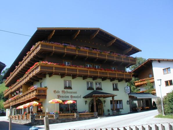 a large building with umbrellas in front of it at Hotel Sonnhof in Wiesing