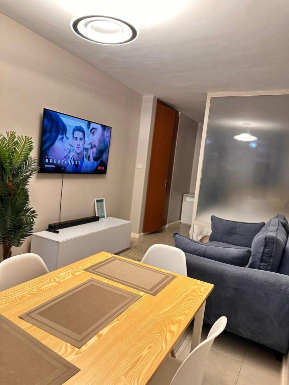 a living room with a couch and a table at Residence Next Door Coral Mega in Kiambu