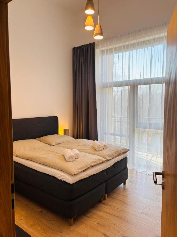 Postel nebo postele na pokoji v ubytování Evergreen Tále Apartments