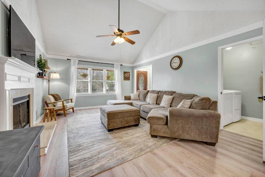 a living room with a couch and a ceiling fan at Sawgrass Cottage 3BR w Deck in Columbia