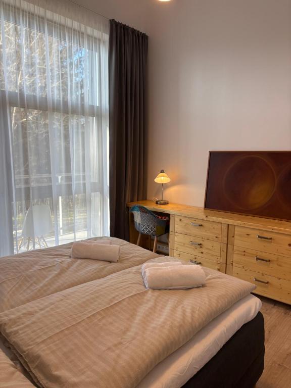 Postel nebo postele na pokoji v ubytování Evergreen Tále Apartments