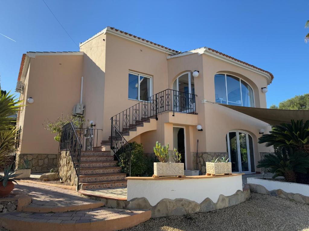 a house with a staircase in front of it at Casa del Rebaldi in Jávea