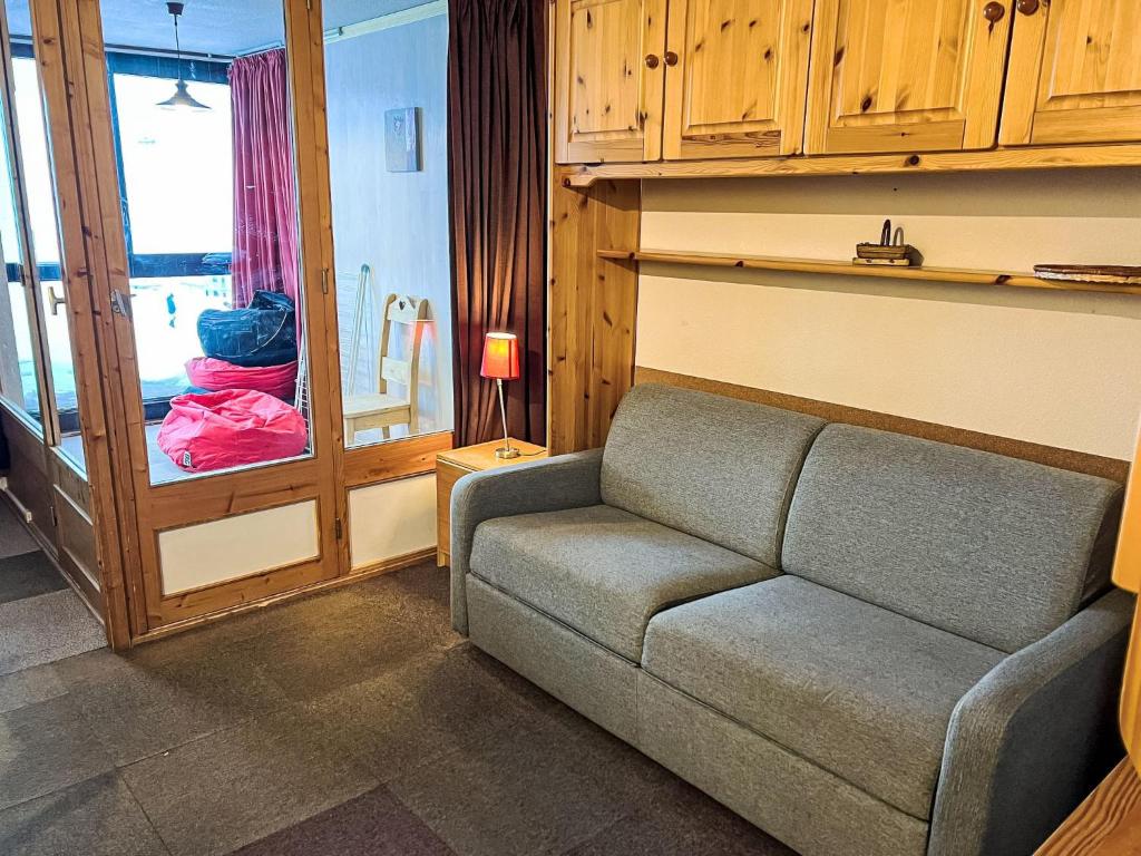 a living room with a couch and a window at Apartment Eskival 106 by Interhome in Val Thorens