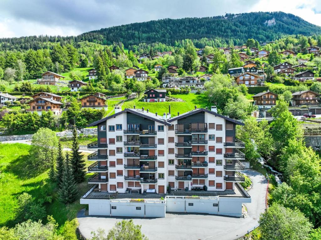 an aerial view of a large apartment building in a village at Apartment Foret E3 by Interhome in Nendaz
