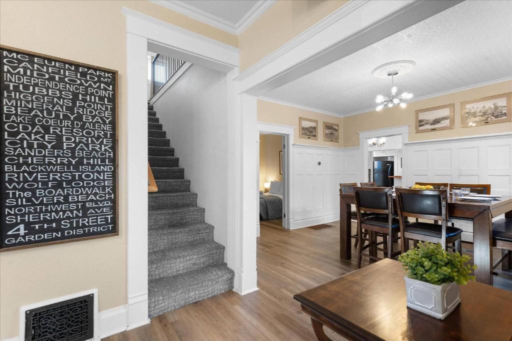 a living room with a staircase and a dining room at The Grand on Garden in Coeur d'Alene