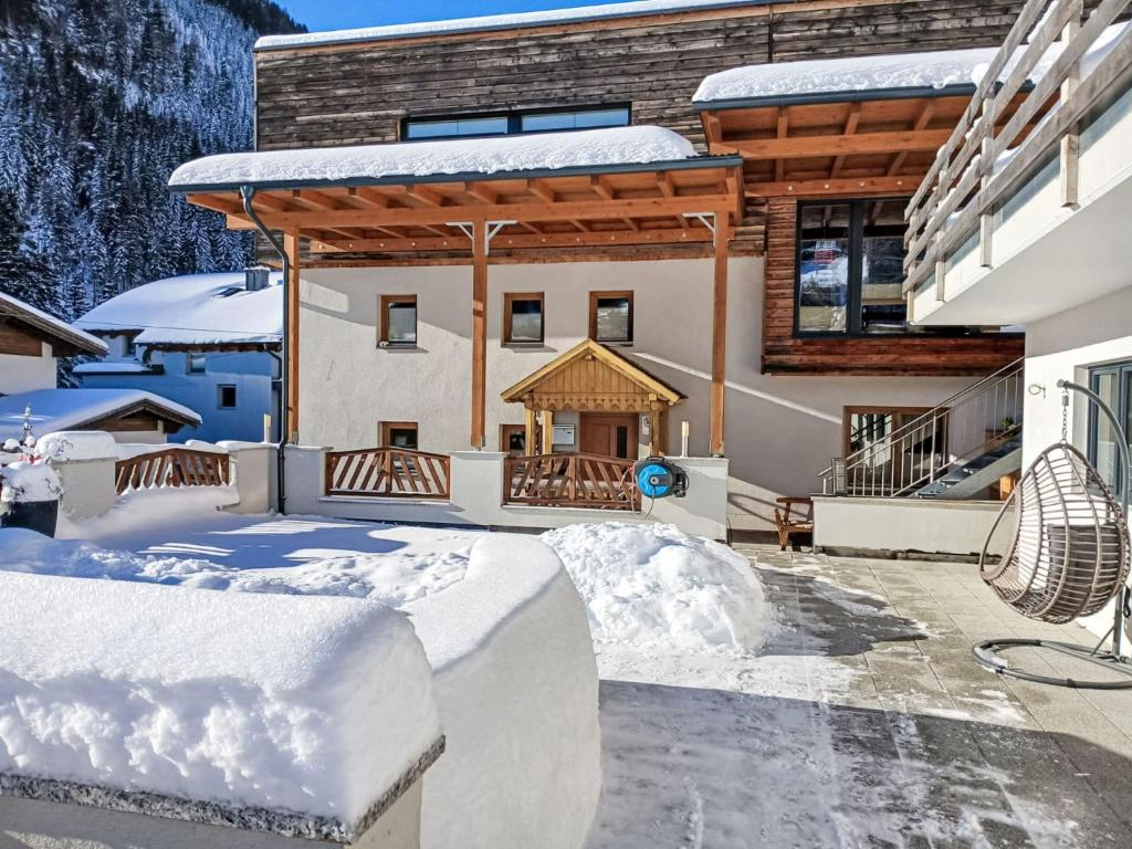 a house in the snow with a gazebo at Apartment Sandra Falch by Interhome in Flirsch