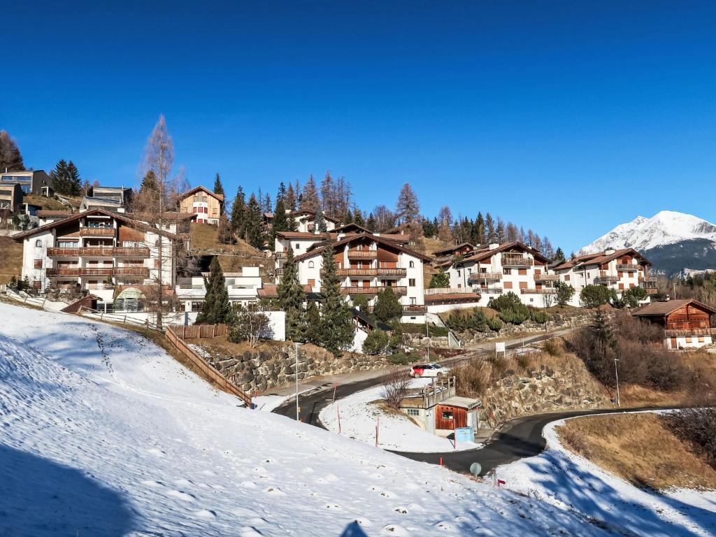 a village in the mountains with snow on the ground at Apartment Toissa A13 by Interhome in Salouf