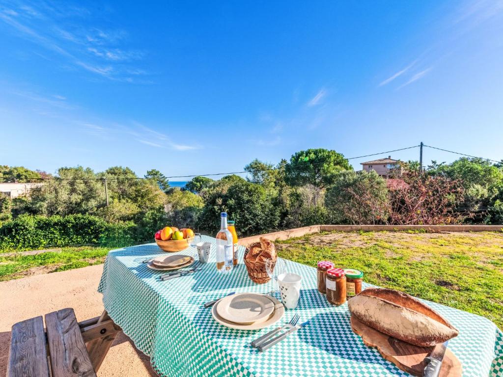 a picnic table with a cat sitting on top of it at Apartment T1 Gabriello by Interhome in Cala dʼOro