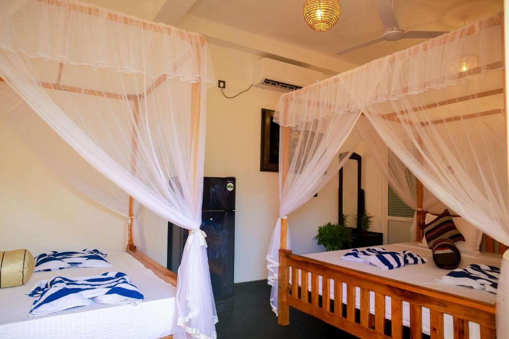 Postel nebo postele na pokoji v ubytování Ruwan Jungle Homestay