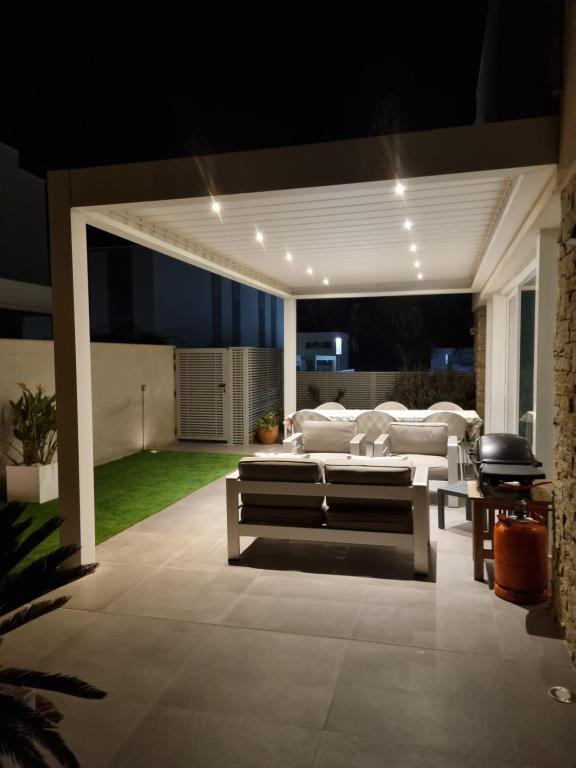 a patio at night with a couch and a table at Casa Vistas al Mar en Alcossebre in Alcossebre