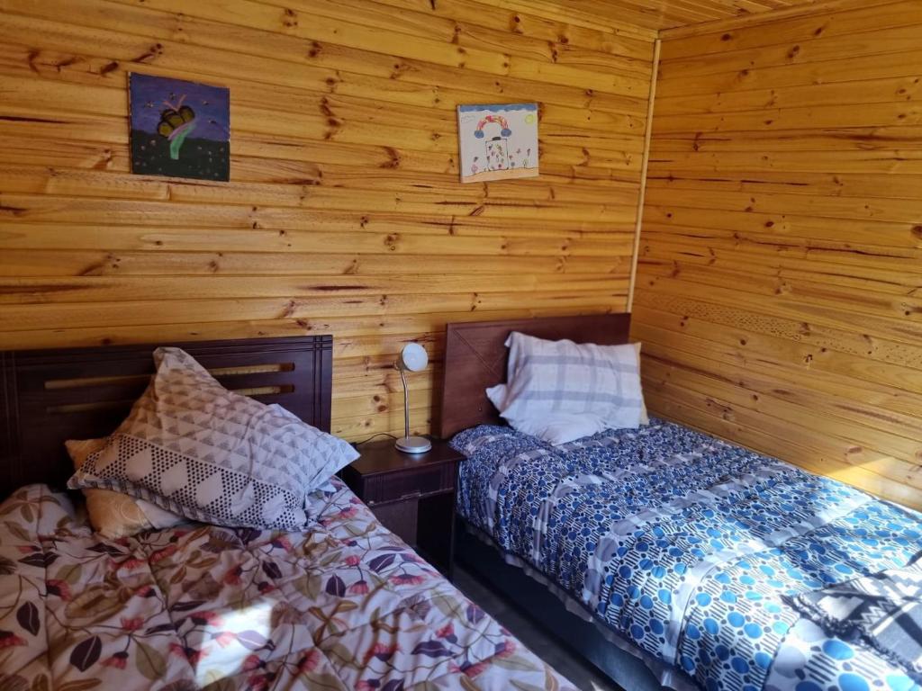 Postel nebo postele na pokoji v ubytování Cabañas Alto Quillay, radal siete tasas