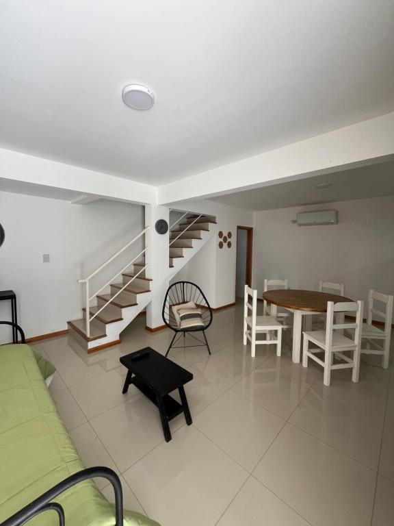 a living room with a staircase and a table and chairs at Apartamento Paseo Plaza Navarro PB in Navarro
