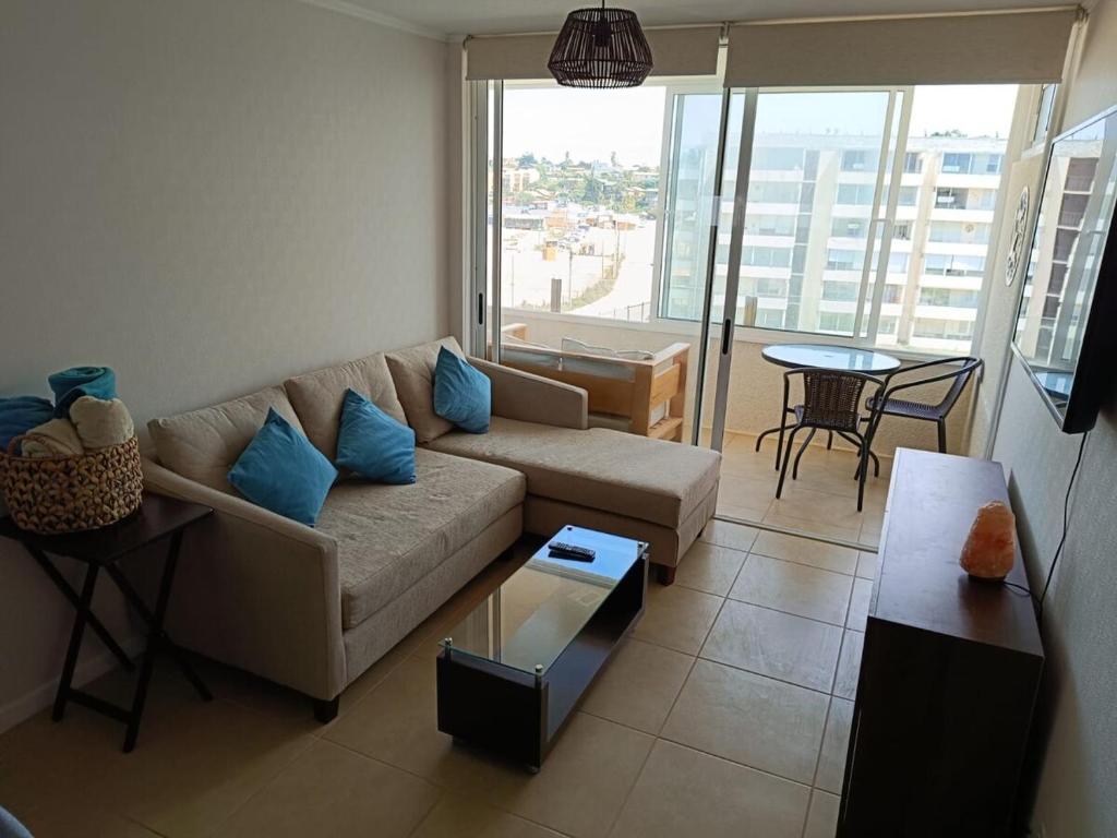 a living room with a couch and a table at Los Molles apartment in Los Molles