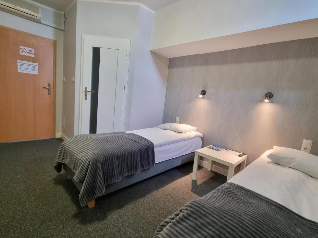 Postel nebo postele na pokoji v ubytování Hotel Orbita