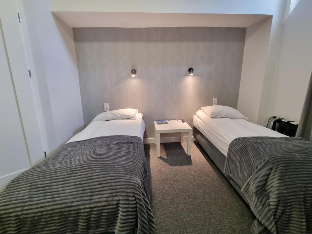 Postel nebo postele na pokoji v ubytování Hotel Orbita