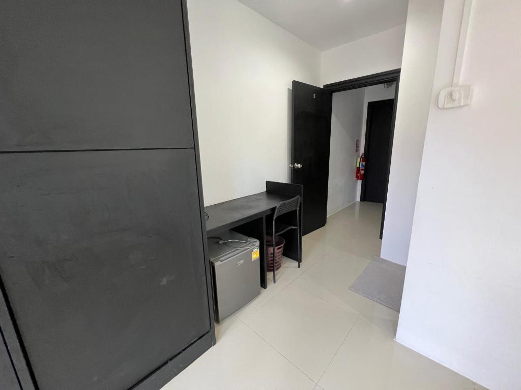 a room with a black desk and a hallway at Patong Easy life 5 in Patong Beach
