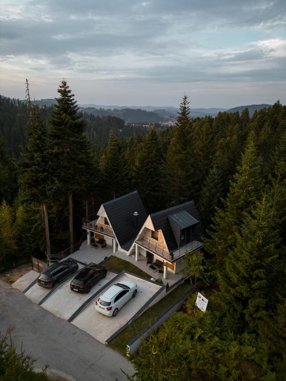an aerial view of a house with cars parked in a parking lot at Zlatar mountain retreat in Nova Varoš