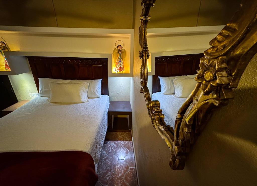 Postel nebo postele na pokoji v ubytování Hotel Casa San Miguel