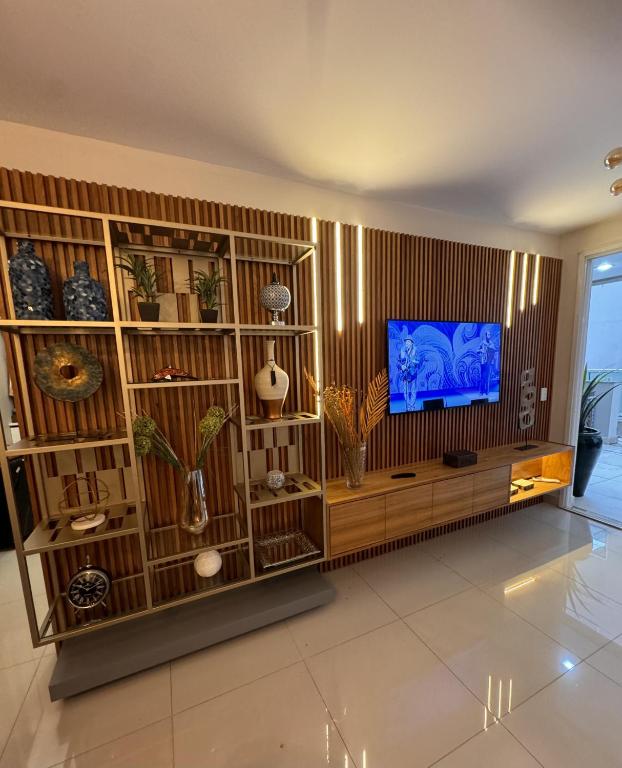 a living room with a entertainment center with a television at Fabuloso - Brisas do Lago in Brasília