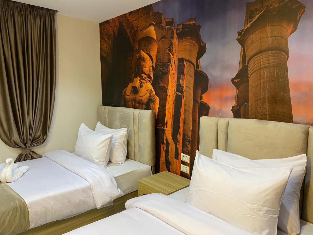 Postel nebo postele na pokoji v ubytování Giza Pyramids Boutique Hotel