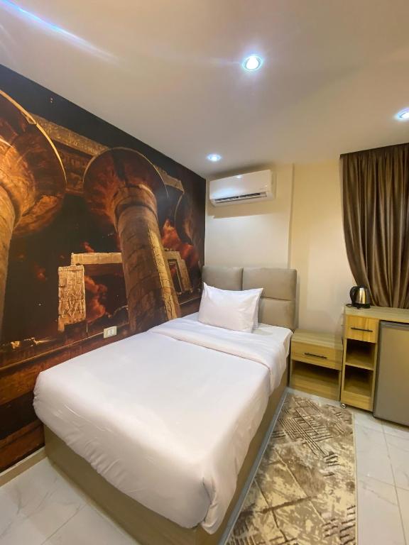 Postel nebo postele na pokoji v ubytování Giza Pyramids Boutique Hotel
