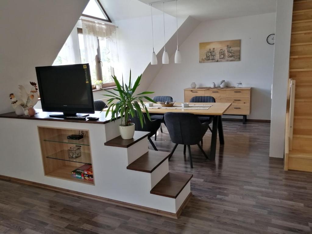 a living room with a table with a computer on it at Moderne und ruhige Ferienwohnung in Feuchtwangen