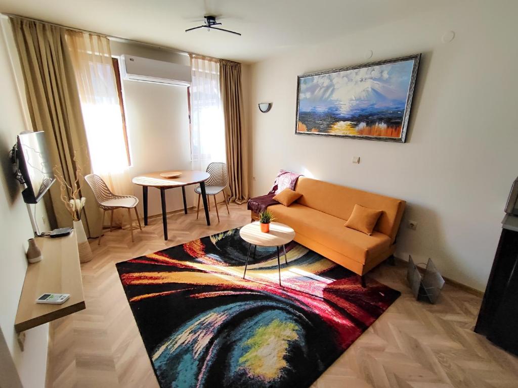 a living room with a couch and a table at Nature Life, 200m to the Lift in Bansko