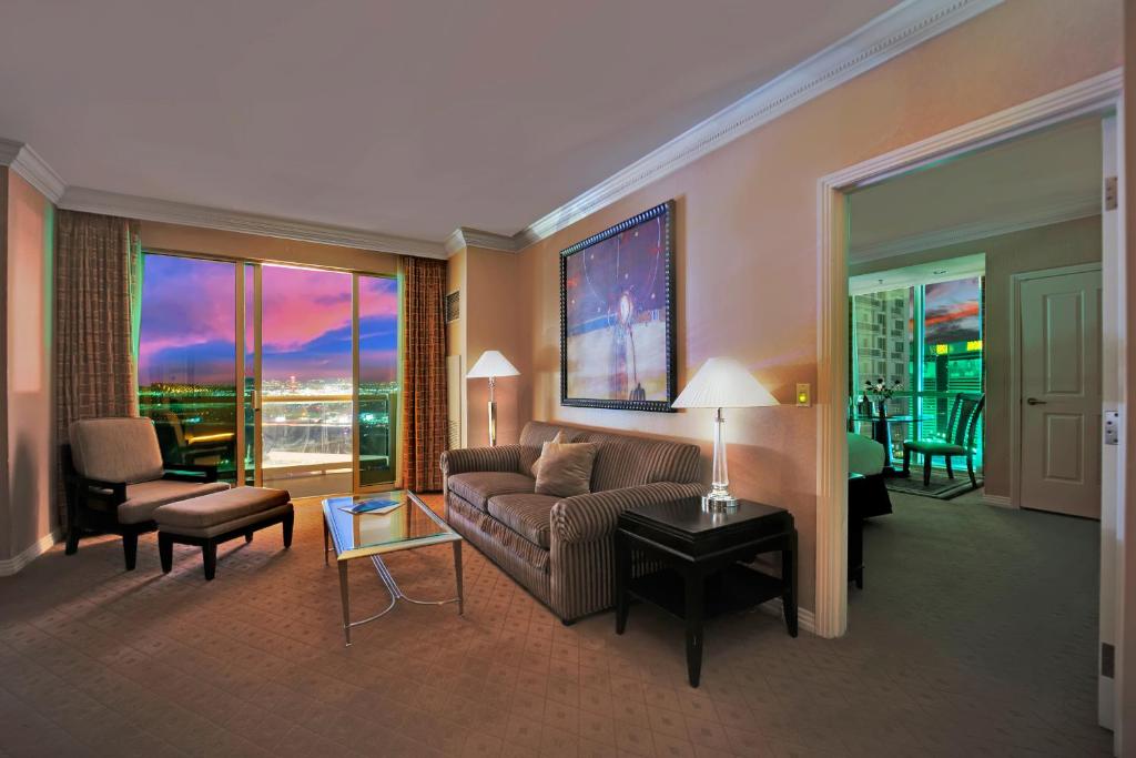 a living room with a couch and a table at Kintsugi Retreat-Condo-StripView-No Resort Fee in Las Vegas