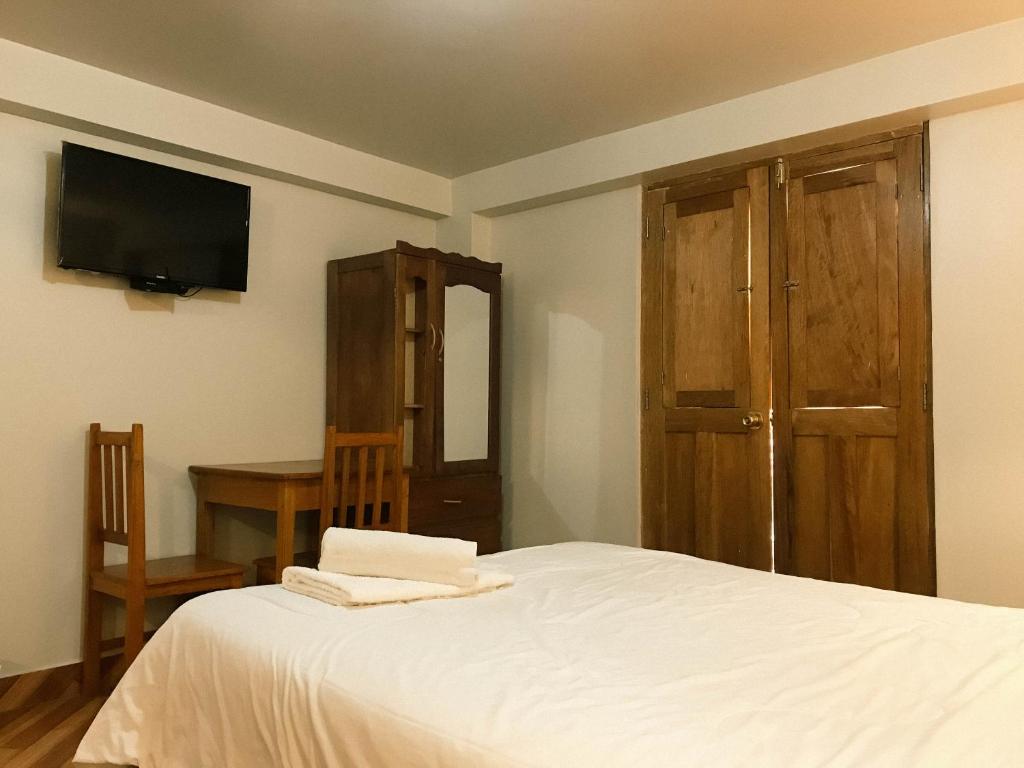 Postel nebo postele na pokoji v ubytování Nafis Casona Apu Linli Pisac
