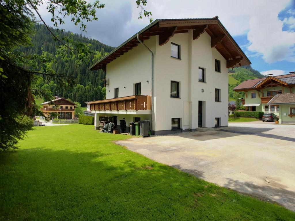 a large white building with a gambrel roof at Amadé in Kleinarl