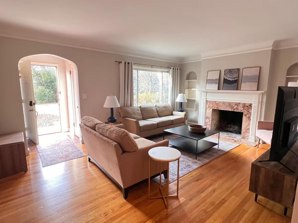 a living room with a couch and a fireplace at Spacious Omaha Retreat in Omaha