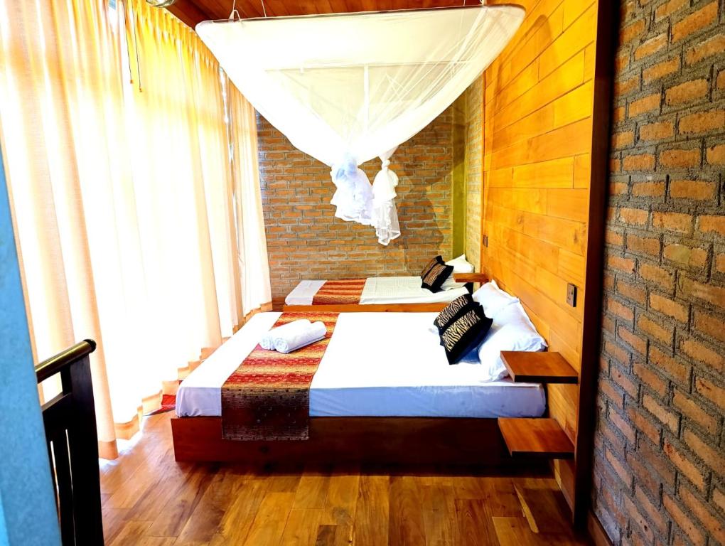 Postel nebo postele na pokoji v ubytování Kandy Bird Villas