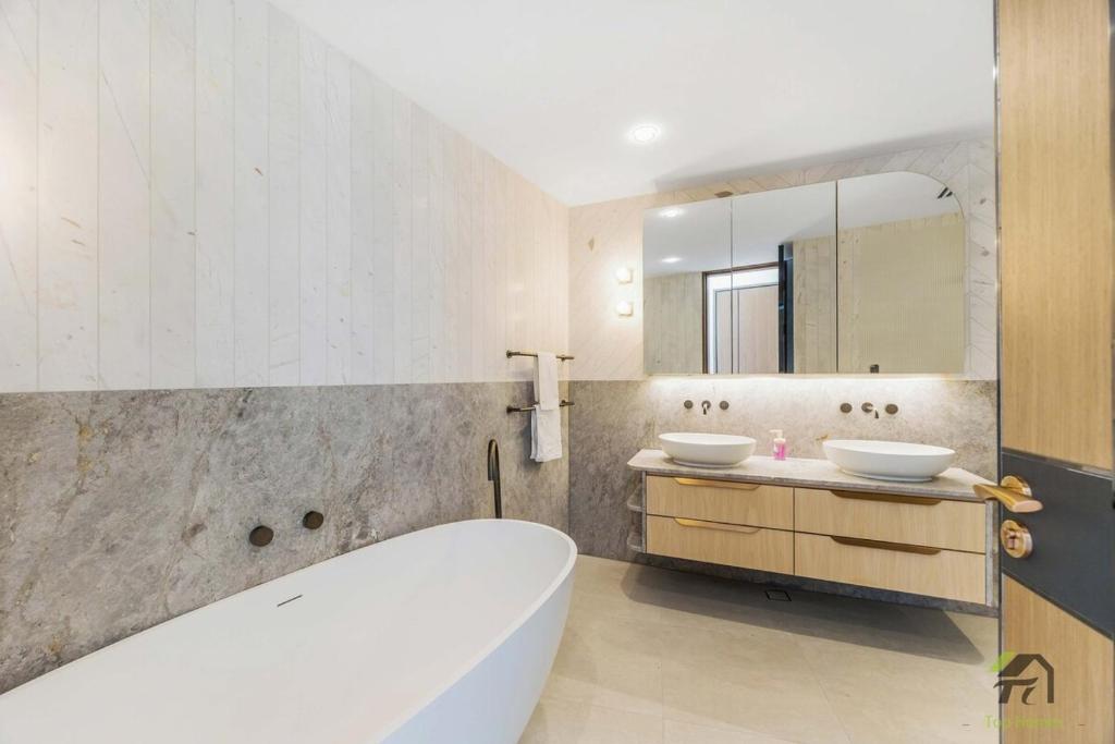 a bathroom with two sinks and a tub and a mirror at Harbour view new year firework in Sydney