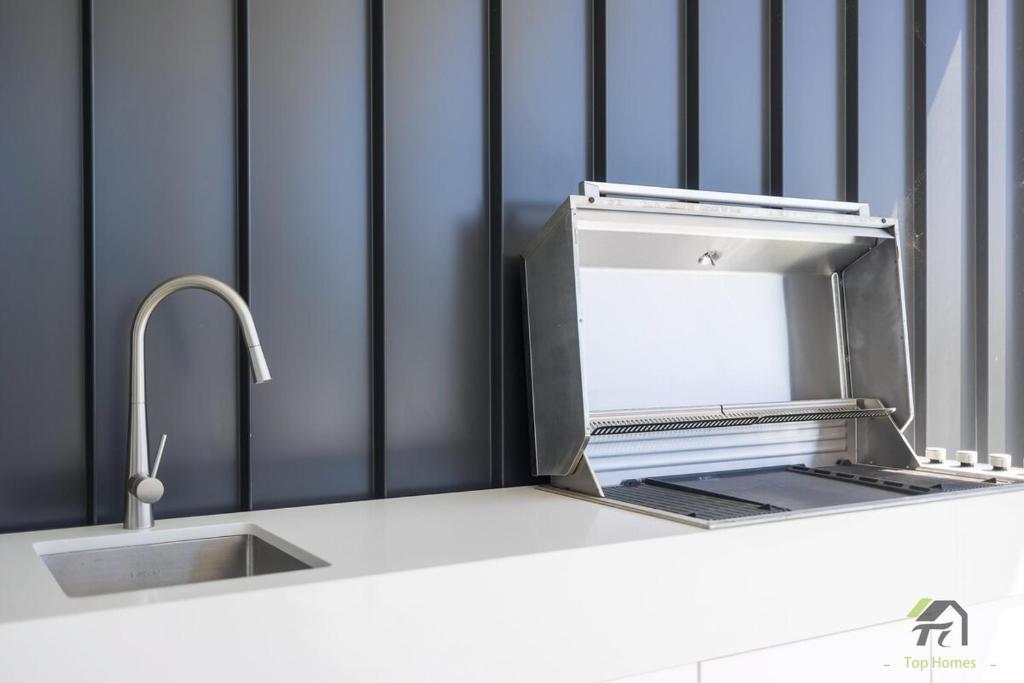 a kitchen counter with a sink and a faucet at Harbour view new year firework in Sydney