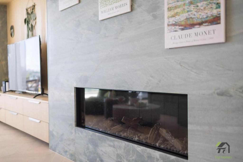 a fireplace in a room with a stone wall at Harbour view new year firework in Sydney
