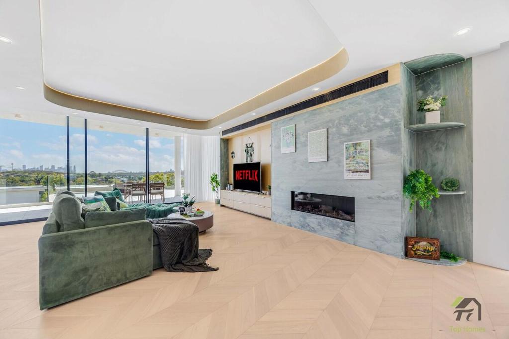 a living room with a couch and a fireplace at Harbour view new year firework in Sydney