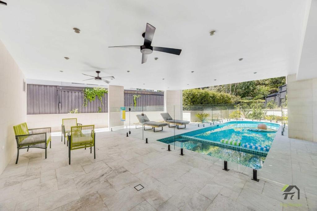 a living room with a swimming pool and chairs at Harbour view new year firework in Sydney