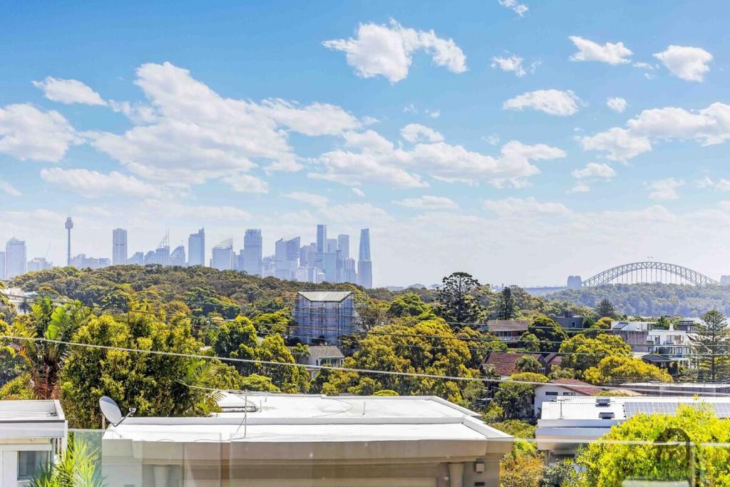 a view of a city skyline with buildings and trees at Harbour view new year firework in Sydney