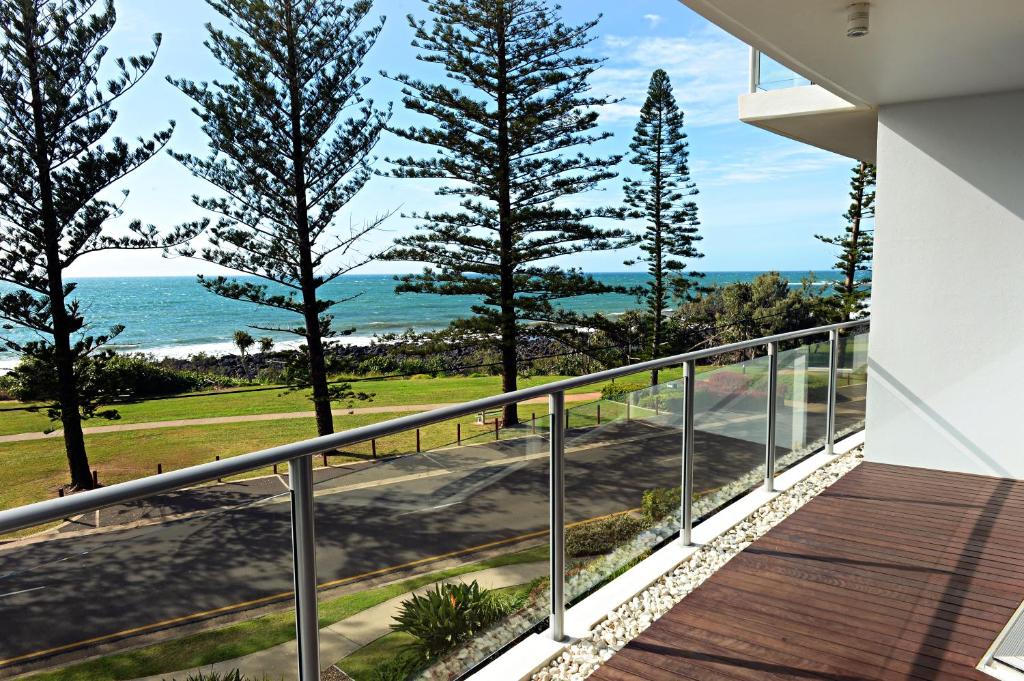 a balcony with a view of the ocean at Manta Bargara in Bargara