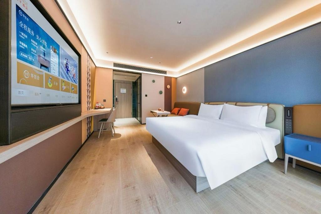 Ένα ή περισσότερα κρεβάτια σε δωμάτιο στο Orange Hotel Guilin Yangshuo West Street Branch