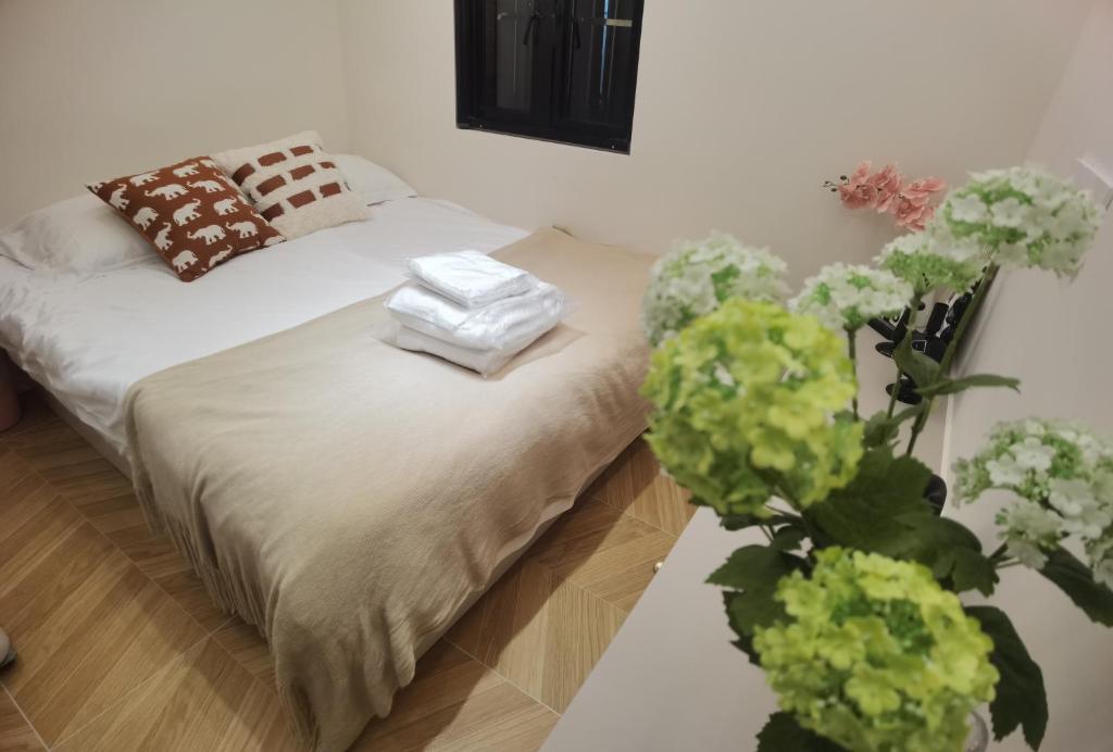 a bedroom with a bed with towels on it at HuanChang in Shanghai