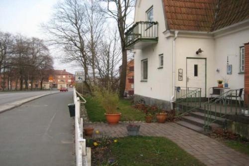 une maison blanche sur le côté d'une rue dans l'établissement Kronans B&B, à Hässleholm