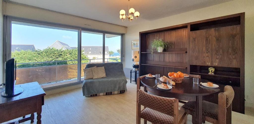 - un salon avec une table et une salle à manger avec vue dans l'établissement Vue Ciel et Mer chez Ginette, à Quiberon