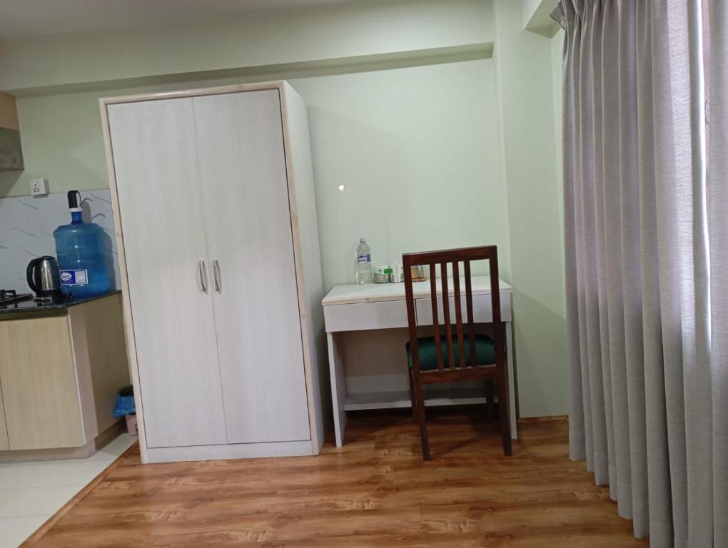 a room with a desk and a chair and a cabinet at Pilachhen 1 bhk in Pātan