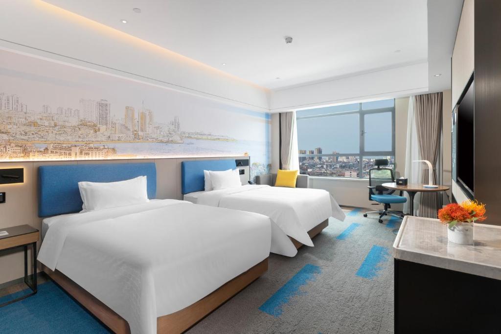 Vuode tai vuoteita majoituspaikassa Hampton by Hilton Qingdao Jiaodong International Airport South