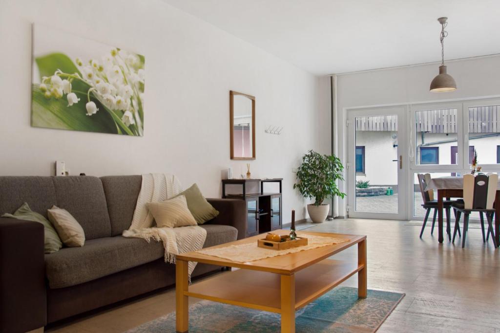 a living room with a couch and a coffee table at Maiglöckchen in Unterwittighausen