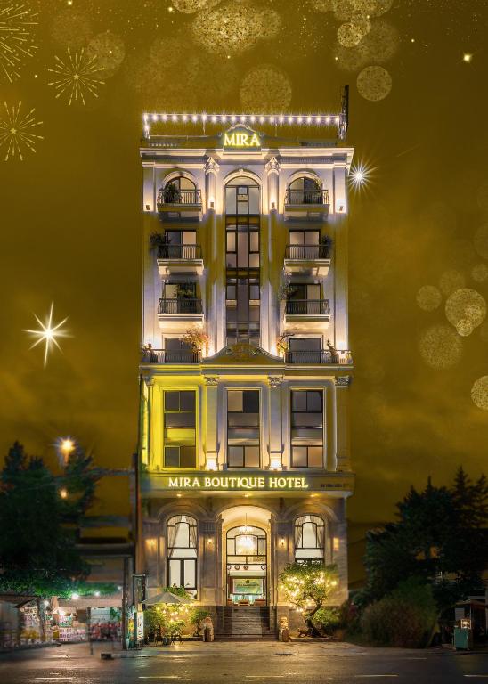 a tall building with lights on it at night at Mira Boutique Hotel Quy Nhon in Quy Nhon