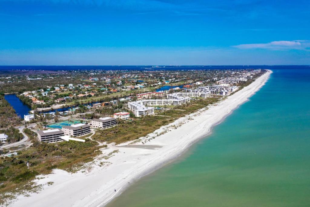 an aerial view of a beach with buildings and the ocean at Sanddollar #A202 in Ybel
