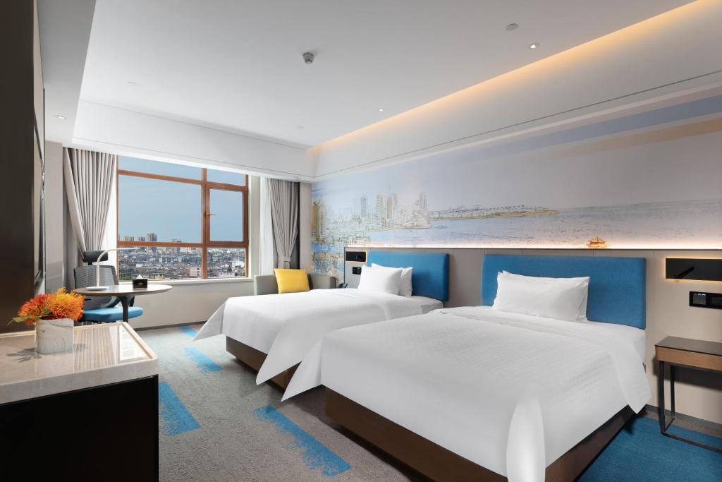 Vuode tai vuoteita majoituspaikassa Hampton by Hilton Qingdao Jiaodong International Airport South